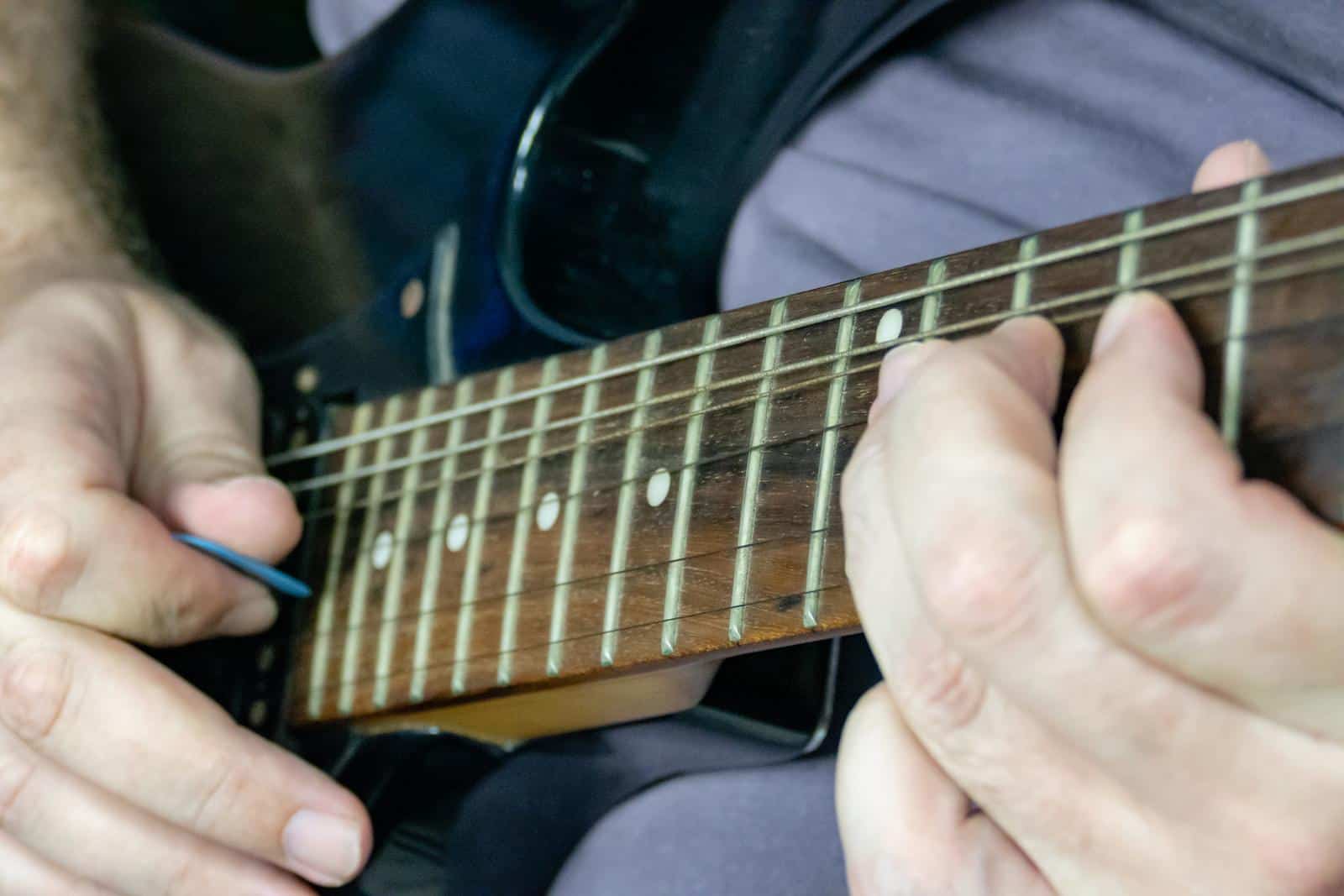 Close up of a man playing the guitar