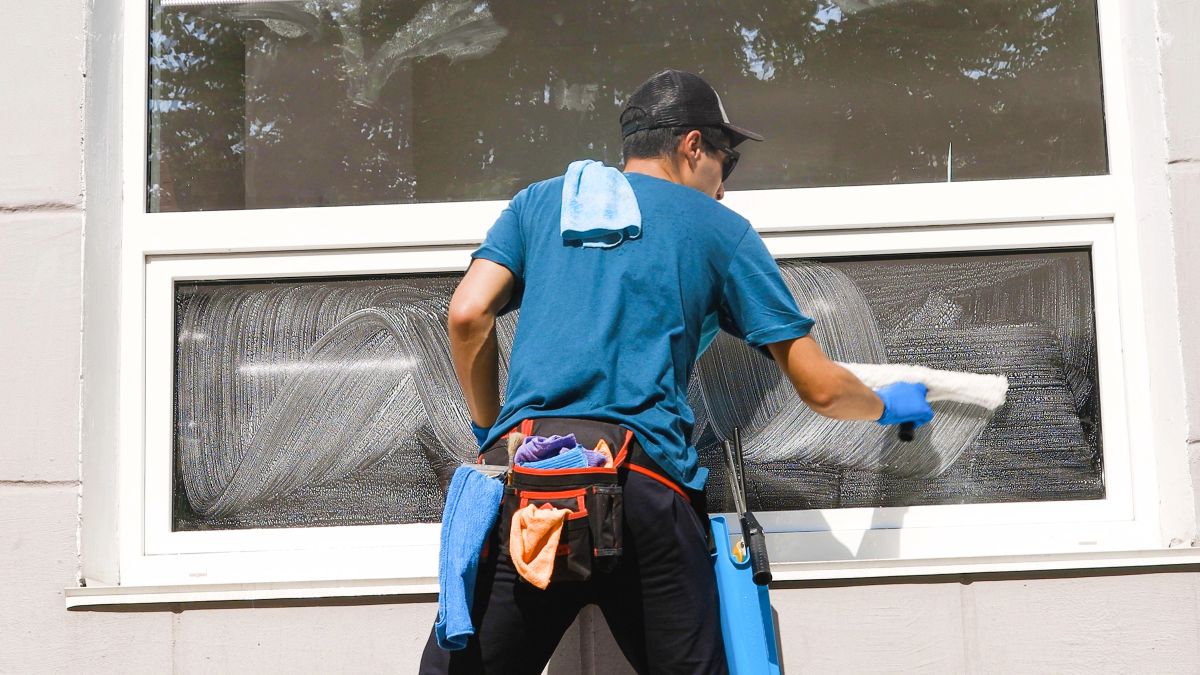 man cleaning exterior windows